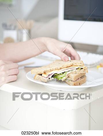 detail of young woman at home in front of computer eating sandwich View Large Photo Image Stock Image - detail of young woman at home in front of computer eating sandwich. Fotosearch