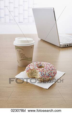 Stock Image - donut cup and laptop computer on table. Fotosearch