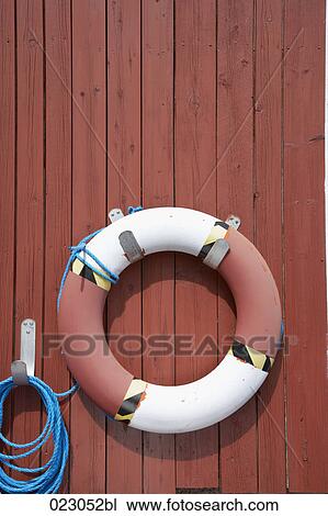life buoy hanging on wall View Large Photo Image Stock Image - life buoy hanging on wall. Fotosearch
