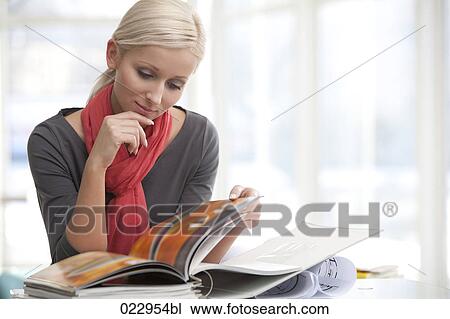 portrait of young blonde businesswoman reading file View Large Photo Image Stock Image - portrait of young blonde businesswoman reading file. Fotosearch