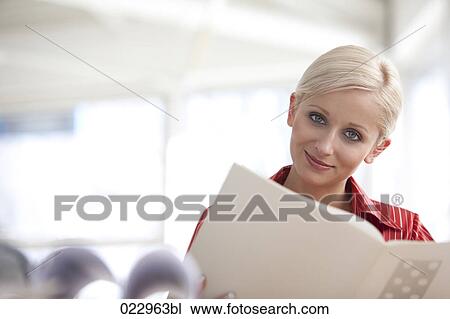 portrait of young blonde businesswoman reading document View Large Photo Image Stock Image - portrait of young blonde businesswoman reading document. Fotosearch