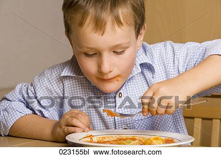 portrait of young boy eating pasta View Large Photo Image Stock Image - portrait of young boy eating pasta. Fotosearch