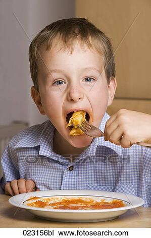 portrait of young boy eating pasta View Large Photo Image Stock Image - portrait of young boy eating pasta. Fotosearch
