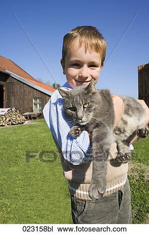 portrait of young boy holding cat View Large Photo Image Stock Image - portrait of young boy holding cat. Fotosearch
