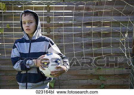 portrait of young boy holding football View Large Photo Image Stock Image - portrait of young boy holding football. Fotosearch