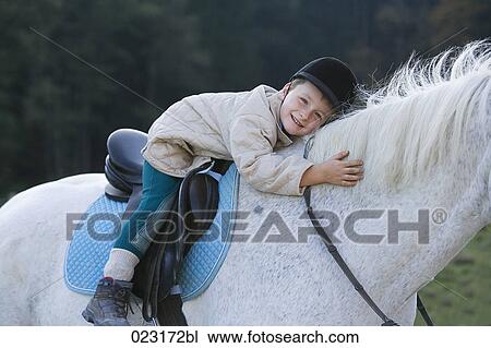 portrait of young boy sitting on white horse View Large Photo Image Stock Image - portrait of young boy sitting on white horse. Fotosearch