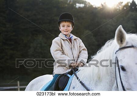 portrait of young boy sitting on white horse View Large Photo Image Stock Image - portrait of young boy sitting on white horse. Fotosearch