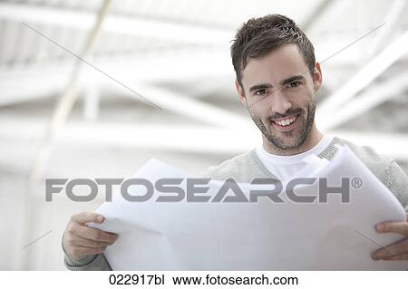 portrait of young businessman holding document View Large Photo Image Stock Image - portrait of young businessman holding document. Fotosearch