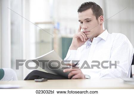 Stock Image - portrait of young businessman with document. Fotosearch