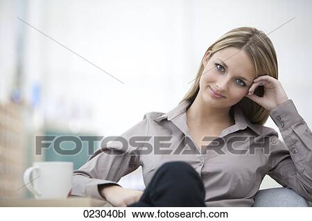 Stock Image - portrait of young businesswoman having coffee break. Fotosearch