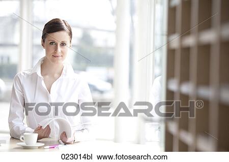 portrait of young businesswoman reading magazine View Large Photo Image Stock Image - portrait of young businesswoman reading magazine. Fotosearch