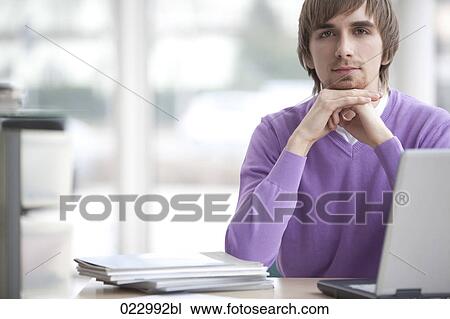 portrait of young man at desk with laptop computer View Large Photo Image Stock Image - portrait of young man at desk with laptop computer. Fotosearch