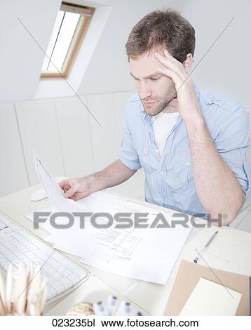 portrait of young man at home reading document View Large Photo Image Stock Image - portrait of young man at home reading document. Fotosearch