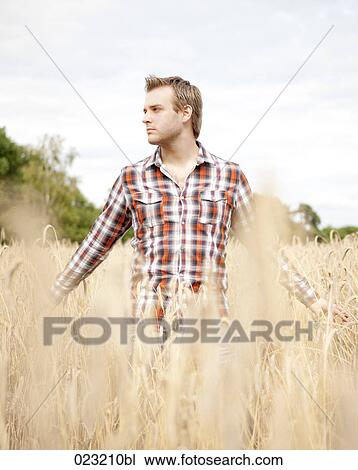 portrait of young man standing in field View Large Photo Image Stock Image - portrait of young man standing in field. Fotosearch