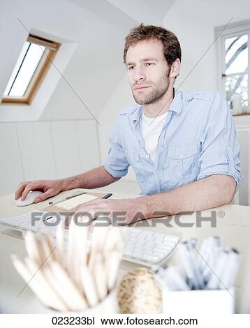 portrait of young man working with computer at home View Large Photo Image Stock Image - portrait of young man working with computer at home. Fotosearch