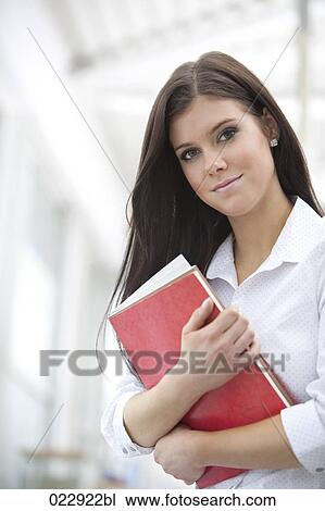portrait of young woman holding books View Large Photo Image Stock Image - portrait of young woman holding books. Fotosearch