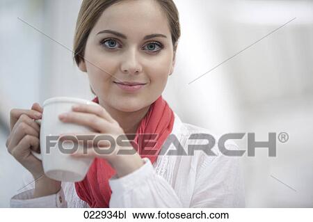 portrait of young woman holding coffee cup View Large Photo Image Stock Image - portrait of young woman holding coffee cup. Fotosearch
