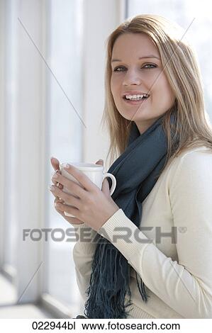 portrait of young woman holding cup View Large Photo Image Stock Image - portrait of young woman holding cup. Fotosearch