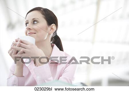 portrait of young woman holding cup View Large Photo Image Stock Image - portrait of young woman holding cup. Fotosearch