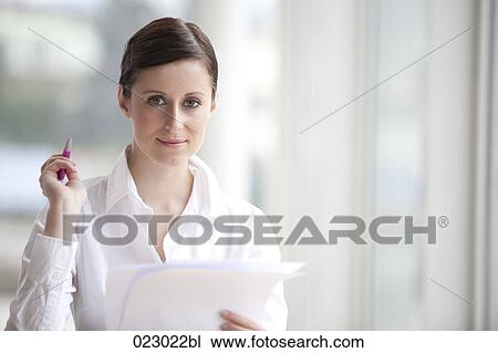 Stock Image - portrait of young woman with document. Fotosearch