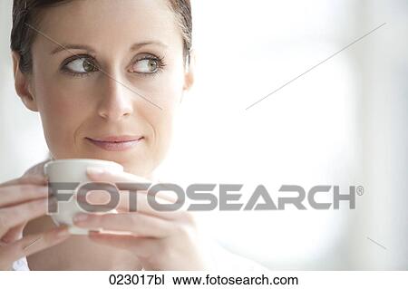 Stock Image - portrait of young woman with espresso cup. Fotosearch