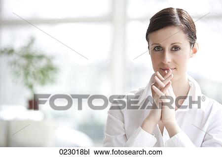 portrait of young woman with folded hands View Large Photo Image Stock Image - portrait of young woman with folded hands. Fotosearch