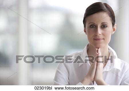 portrait of young woman with folded hands View Large Photo Image Stock Image - portrait of young woman with folded hands. Fotosearch
