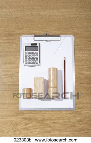 Stock Image - still life of clipboard calculator and wooden pieces. Fotosearch