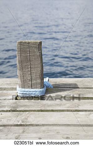 wooden pole with rope on pier View Large Photo Image Stock Image - wooden pole with rope on pier. Fotosearch