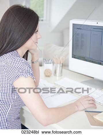 younf woman at home looking at computer screen View Large Photo Image Stock Image - younf woman at home looking at computer screen. Fotosearch