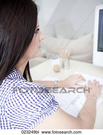 younf woman at home looking at computer screen View Large Photo Image Stock Image - younf woman at home looking at computer screen. Fotosearch