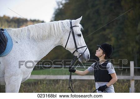 young boy holding white horse View Large Photo Image Stock Image - young boy holding white horse. Fotosearch