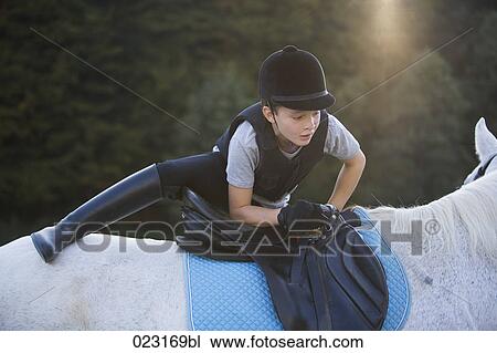 young boy trying to get on white horse View Large Photo Image Stock Image - young boy trying to get on white horse. Fotosearch