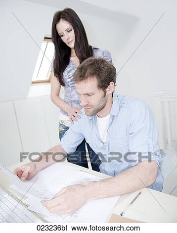 young couple at home studying document together View Large Photo Image Stock Image - young couple at home studying document together. Fotosearch