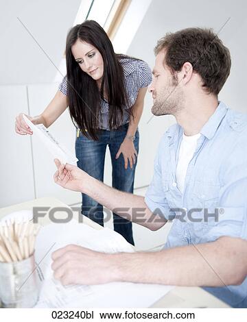 young couple at home studying document together View Large Photo Image Stock Image - young couple at home studying document together. Fotosearch