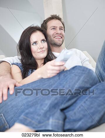 young couple at home watching television View Large Photo Image Stock Image - young couple at home watching television. Fotosearch