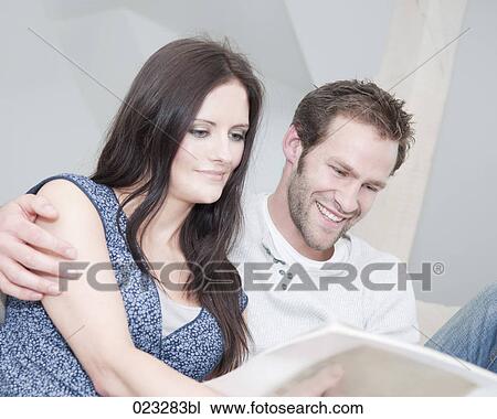 young couple reading magazine together View Large Photo Image Stock Image - young couple reading magazine together. Fotosearch