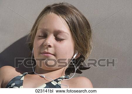 young girl listening to music with earphones in summer View Large Photo Image Stock Image - young girl listening to music with earphones in summer. Fotosearch
