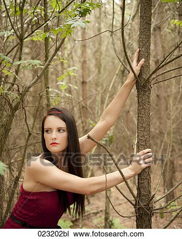 young woman in red dress in a forest View Large Photo Image Stock Image - young woman in red dress in a forest. Fotosearch