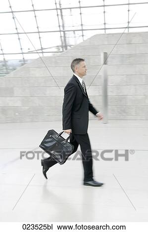 businessman walking through hall View Large Photo Image Stock Image - businessman walking through hall. Fotosearch