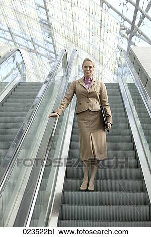 businesswoman on escalator View Large Photo Image Stock Image - businesswoman on escalator. Fotosearch