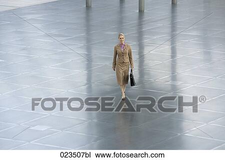 businesswoman walking through hall View Large Photo Image Stock Image - businesswoman walking through hall. Fotosearch