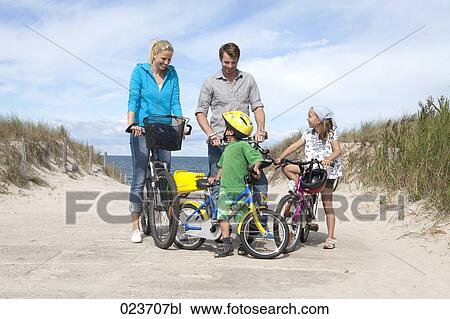 family cycling together at seaside View Large Photo Image Stock Image - family cycling together at seaside. Fotosearch
