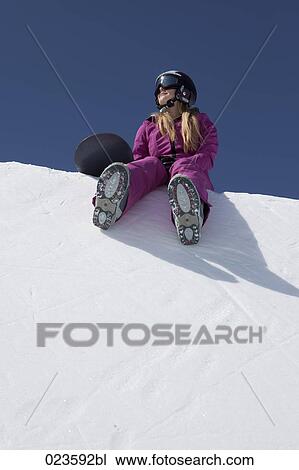 female snowboarder sitting on snow View Large Photo Image Stock Image - female snowboarder sitting on snow. Fotosearch