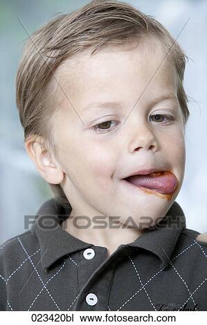 headshot of young boy licking lips View Large Photo Image Stock Image - headshot of young boy licking lips. Fotosearch