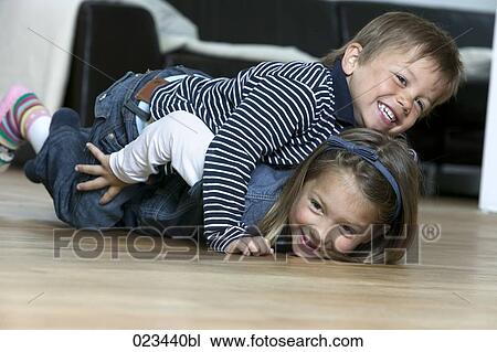 little boy and girl having at home fun together View Large Photo Image Stock Image - little boy and girl having at home fun together. Fotosearch