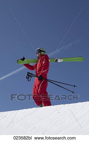 man in mountains carrying skis View Large Photo Image Stock Image - man in mountains carrying skis. Fotosearch