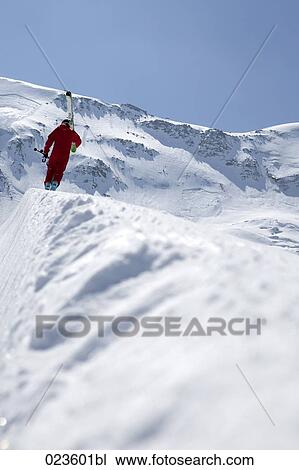 man in mountains carrying skis View Large Photo Image Stock Image - man in mountains carrying skis. Fotosearch