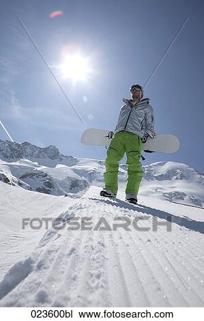 man in the mountains carrying snowboard View Large Photo Image Stock Image - man in the mountains carrying snowboard. Fotosearch