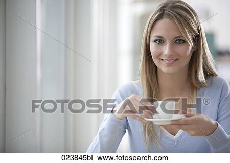 Stock Image - portrait of blonde businesswoman having coffee break. Fotosearch